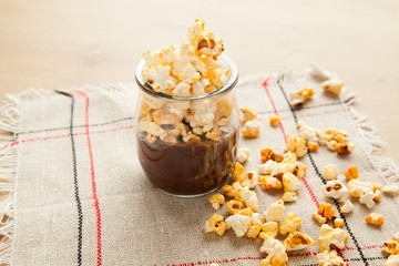 Chocolate dessert with popcorn on wooden table. Homemade cacao tasty pudding.