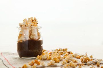 Chocolate dessert with popcorn on wooden table. Homemade cacao tasty pudding.