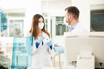 Two chemists doing blood tests in a lab