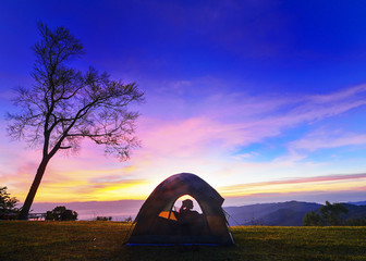 Fototapeta na wymiar Watching the sunset in tent.