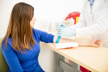 Doctor putting a rubber band on patient