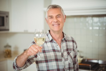Senior man holding glass of wine