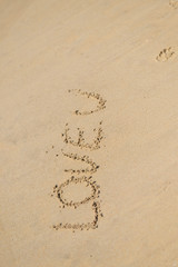 LOVE U sign text message on the beach, closeup top view