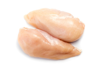 Two raw chicken breasts on a white background