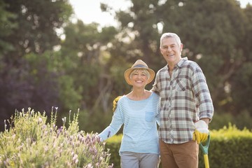 Senior couple standing in backyard