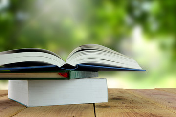 Open books and blur nature background.
