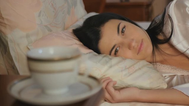 Close-up - woman laying in the bed and relaxing