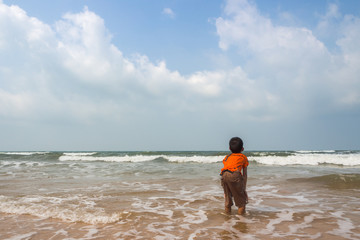 Obraz premium boy playing on the beach in the water