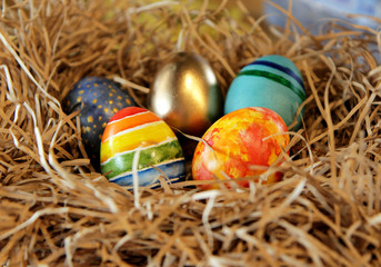 Fototapeta na wymiar Easter colorful eggs in the nest, close-up