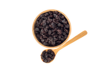 Dried raisins in wooden cup and spoon on white background.
