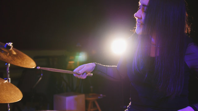 Girl rock musician - female drummer performing