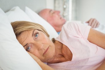 Senior woman resting on bed