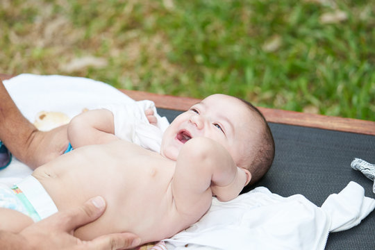 A baby smiling with his mouth open