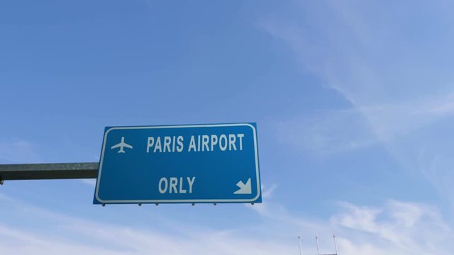 paris orly airport sign airplane passing overhead