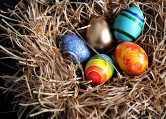 Fototapeta na wymiar Easter colorful eggs in the nest, close-up.