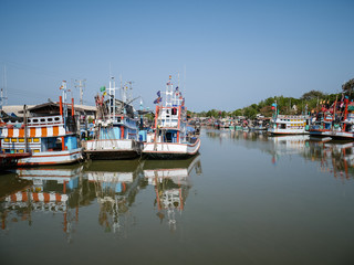 Thai traditional fishing boat, quiet and peaceful water with blue sky