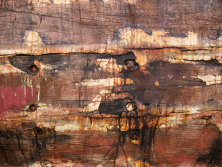Detail and closeup of old and colored boat wooden hull, old painting with cracks and wood texture, amazing picturesque background looking like modern abstract painting