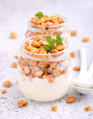 Fototapeta na wymiar healthy breakfast: yogurt with muesli in jars