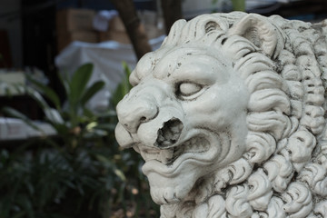 Fototapeta na wymiar Lion stone on the garden.