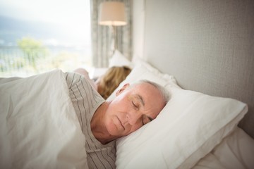 Fototapeta na wymiar Senior couple sleeping on bed 