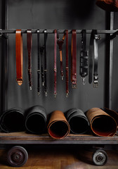 leather straps on the rack near the wall
