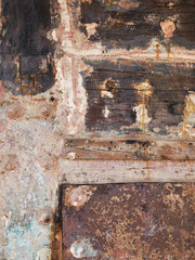 Detail and closeup of old and colored boat wooden hull, old painting with cracks and wood texture, amazing picturesque background looking like modern abstract painting