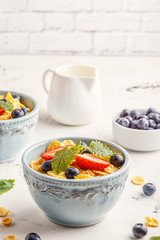 Healthy breakfast - corn flakes with fruits and berries.