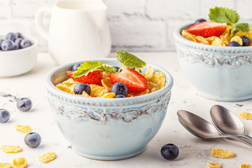 Healthy breakfast - corn flakes with fruits and berries. © tbralnina