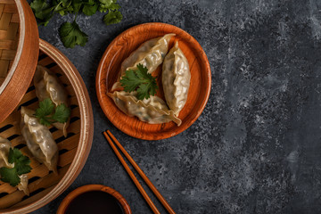 Fresh dumplings on a dark stone background.
