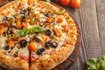 Vegetarian pizza with mozzarella cheese, tomatoes, champignons.