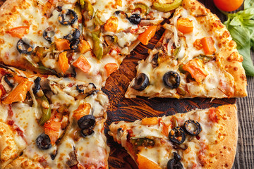 Vegetarian pizza with mozzarella cheese, tomatoes, champignons.