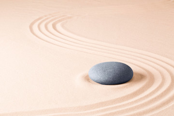 Fototapeta na wymiar Zen meditation stone garden background. Stone on fine sand standing for balance, harmony concentration and relaxation...