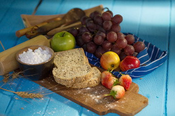 whole wheat bread and Fresh fruit on blue table background.