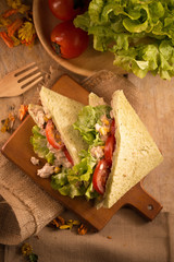 fresh made Tuna Sandwich on Wooden table in Golden Light. selective focus