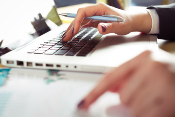 Female hand on a laptop keyboard