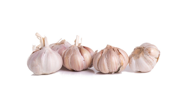 Fresh organic garlic, cloves and cutted garlic clove isolated on white background.