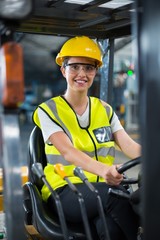 Portrait of smiling female factory worker driving forklift © WavebreakMediaMicro