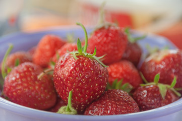 ripe juicy strawberries taken closeup lying in a lavender dish