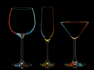 Silhouette of multicolor different glasses on black background