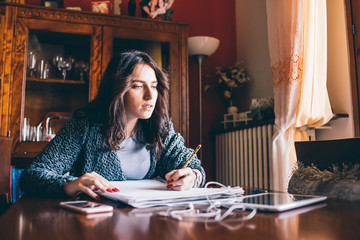 Fototapeta premium young beautiful woman drawing on a sketchbook - artist, creative, illustrator concept