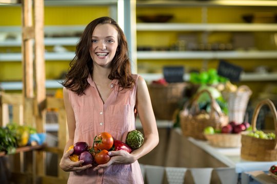 Woman holding vegetables at grocery store
