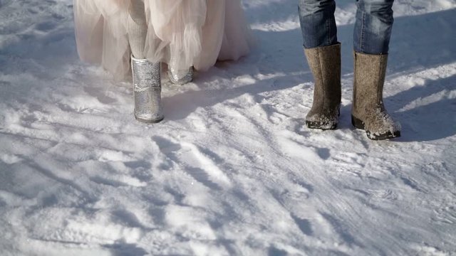 Man and woman walking in a park at winter sunny day