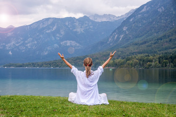 Woman meditating at the lake