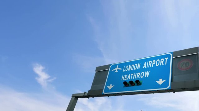 plane flying over heathrow airport signboard
