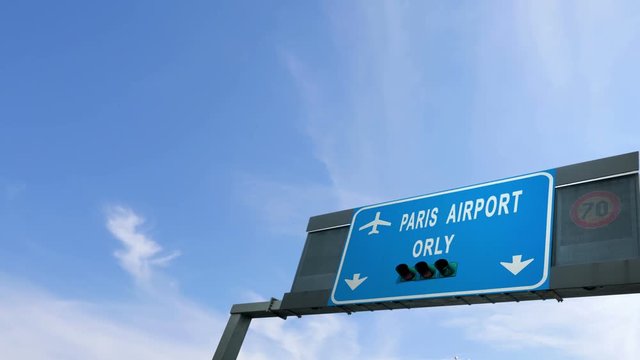 plane flying over paris orly airport sign