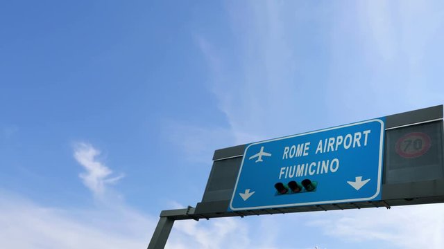 airplane flying over rome airport signboard