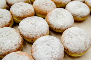 Fototapeta na wymiar Donuts sprinkled with powdered sugar.