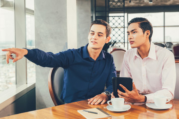Business Partners Discussing Project in Restaurant