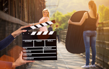 Clapperboard sign hold by female hands.