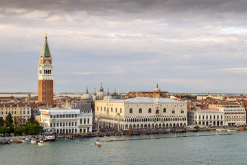 Obraz premium Venetian aerial view from the cruise ship which leaves the port of Venice (Venezia Terminal Passegeri Porto) with St Mark's Campanile bell tower of St Mark's Basilica. Italy.